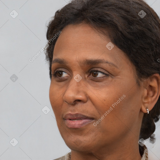 Joyful white adult female with medium  brown hair and brown eyes