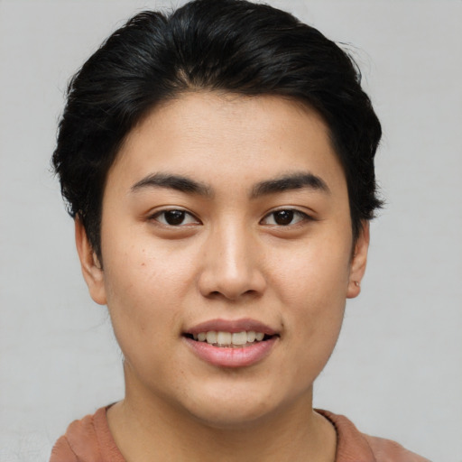 Joyful asian young-adult female with short  brown hair and brown eyes