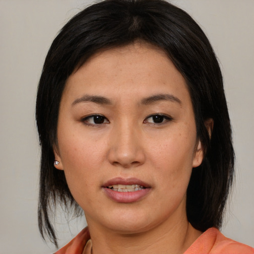 Joyful asian young-adult female with medium  black hair and brown eyes