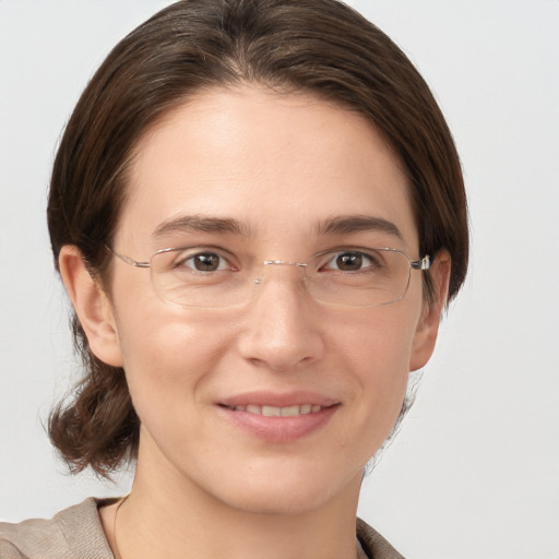 Joyful white young-adult female with medium  brown hair and grey eyes