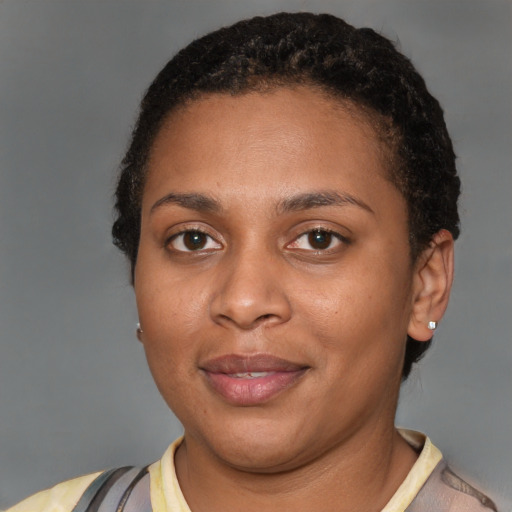 Joyful black young-adult female with short  brown hair and brown eyes