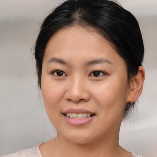Joyful asian young-adult female with medium  brown hair and brown eyes