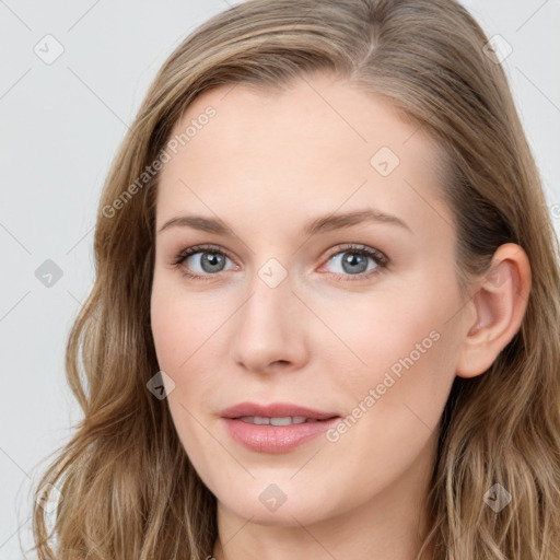 Joyful white young-adult female with long  brown hair and blue eyes