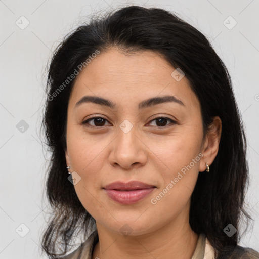 Joyful latino adult female with medium  brown hair and brown eyes