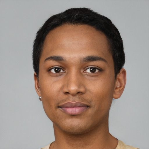 Joyful black young-adult male with short  black hair and brown eyes