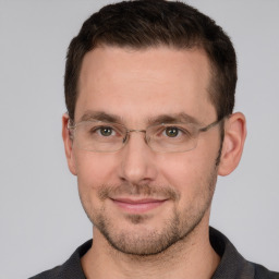 Joyful white adult male with short  brown hair and grey eyes