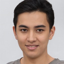 Joyful asian young-adult male with short  brown hair and brown eyes