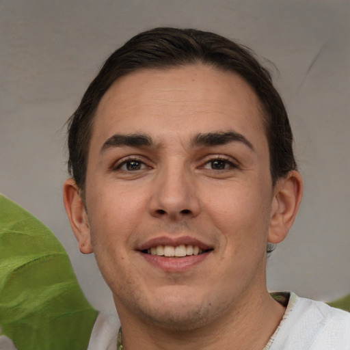 Joyful white young-adult male with short  brown hair and brown eyes