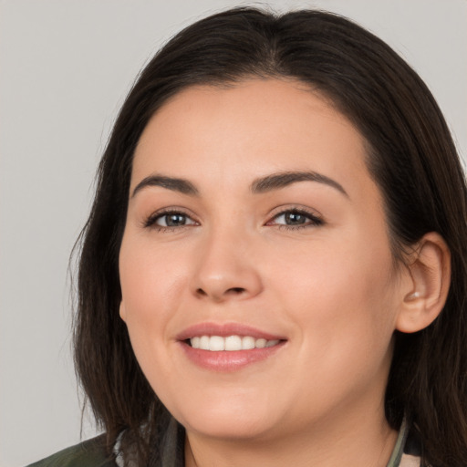 Joyful white young-adult female with long  brown hair and brown eyes