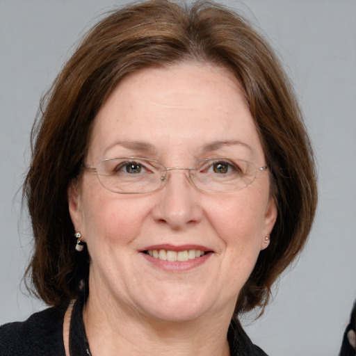 Joyful white adult female with medium  brown hair and blue eyes