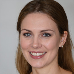 Joyful white young-adult female with long  brown hair and grey eyes