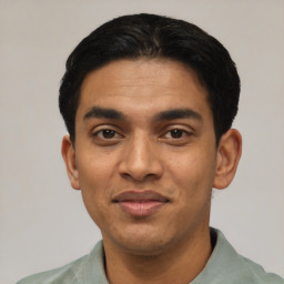 Joyful latino young-adult male with short  black hair and brown eyes