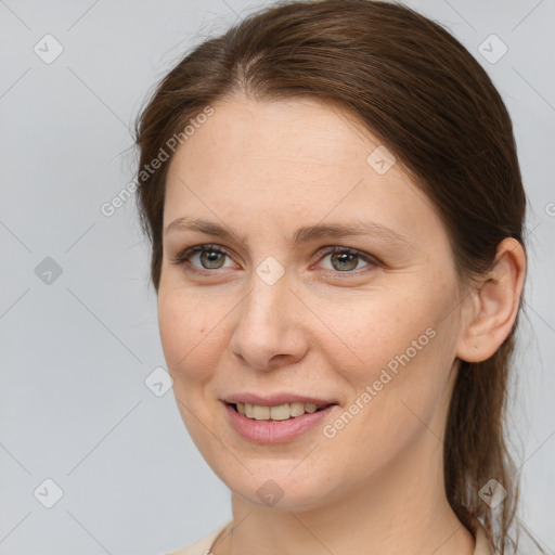 Joyful white young-adult female with medium  brown hair and grey eyes