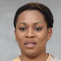 Joyful black young-adult female with short  brown hair and brown eyes
