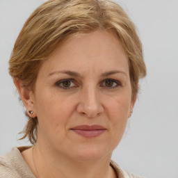 Joyful white adult female with medium  brown hair and grey eyes