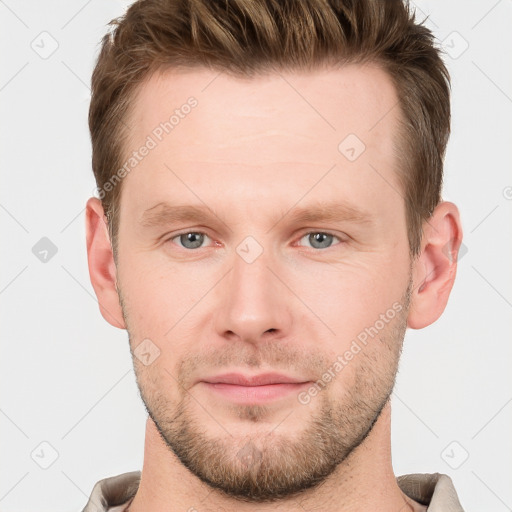 Joyful white young-adult male with short  brown hair and grey eyes