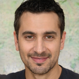 Joyful white adult male with short  brown hair and brown eyes