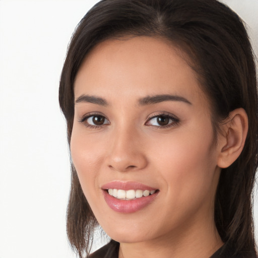 Joyful white young-adult female with long  brown hair and brown eyes