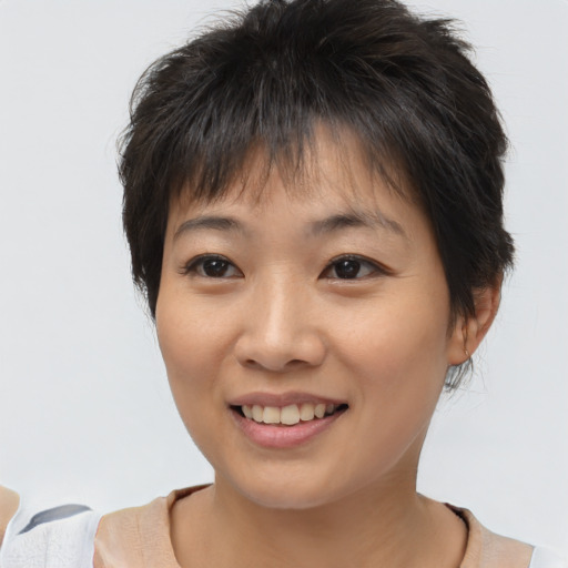 Joyful asian young-adult female with short  brown hair and brown eyes