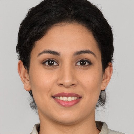 Joyful white young-adult female with medium  brown hair and brown eyes