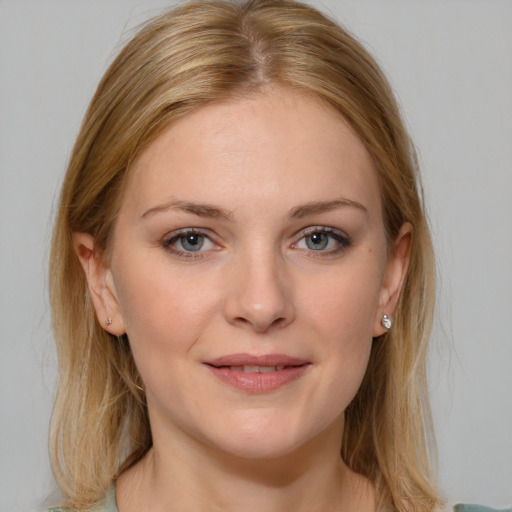 Joyful white young-adult female with medium  brown hair and blue eyes