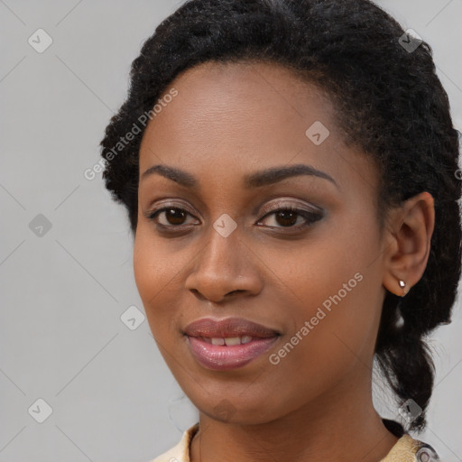 Joyful black young-adult female with medium  black hair and brown eyes