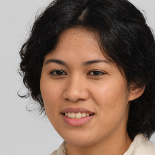 Joyful asian young-adult female with medium  brown hair and brown eyes