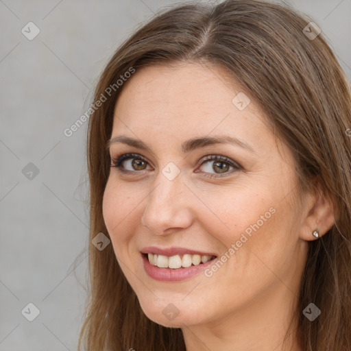 Joyful white young-adult female with long  brown hair and brown eyes