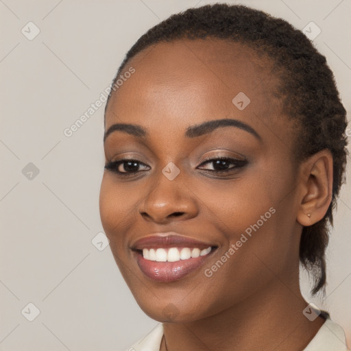 Joyful black young-adult female with long  brown hair and brown eyes