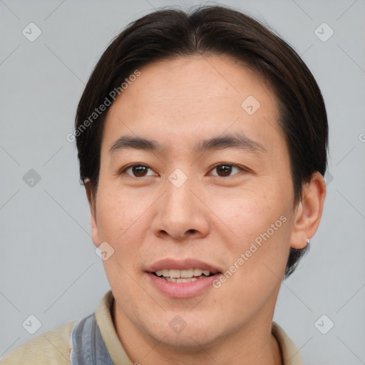 Joyful asian young-adult male with short  brown hair and brown eyes