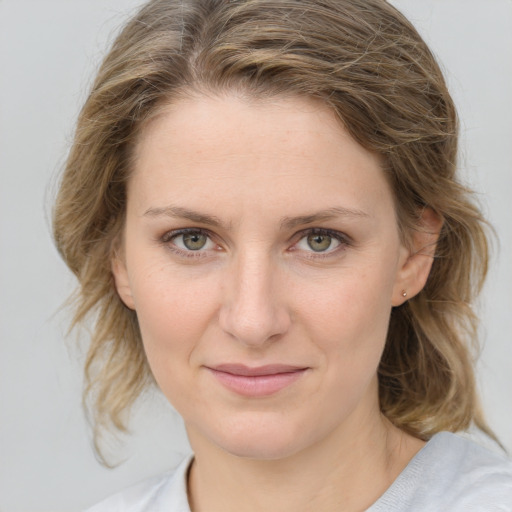 Joyful white young-adult female with medium  brown hair and blue eyes