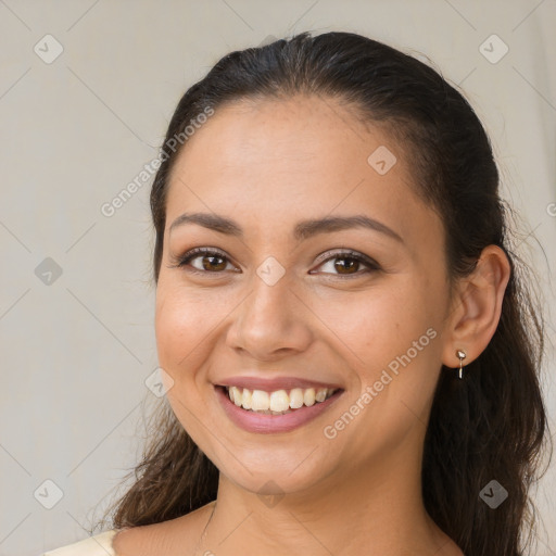 Joyful latino young-adult female with long  brown hair and brown eyes