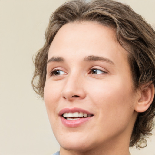 Joyful white young-adult female with medium  brown hair and green eyes