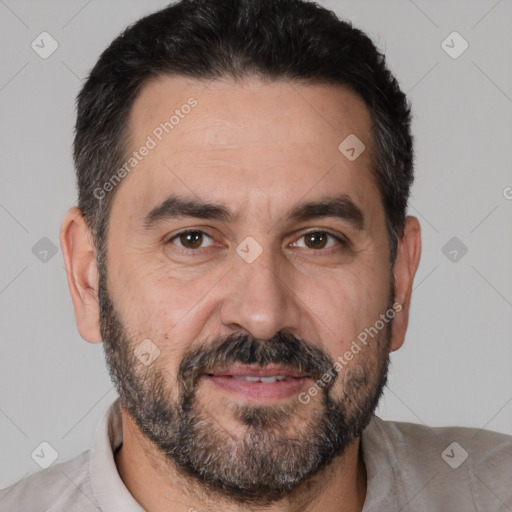 Joyful white adult male with short  black hair and brown eyes