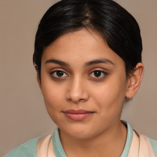 Joyful latino young-adult female with medium  brown hair and brown eyes