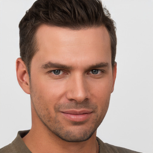 Joyful white young-adult male with short  brown hair and brown eyes