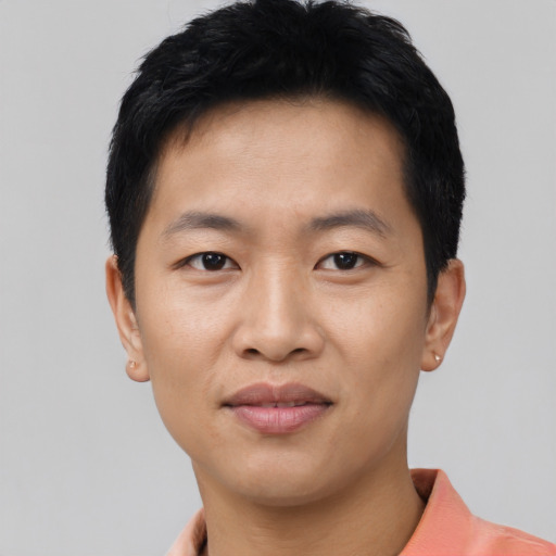 Joyful asian young-adult male with short  black hair and brown eyes