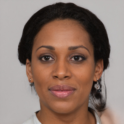 Joyful black young-adult female with medium  black hair and brown eyes