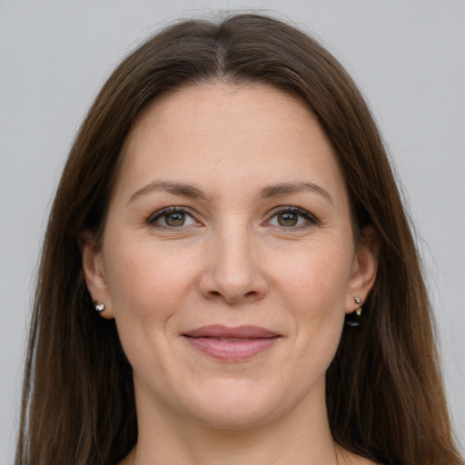 Joyful white adult female with long  brown hair and grey eyes