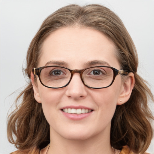 Joyful white young-adult female with medium  brown hair and blue eyes