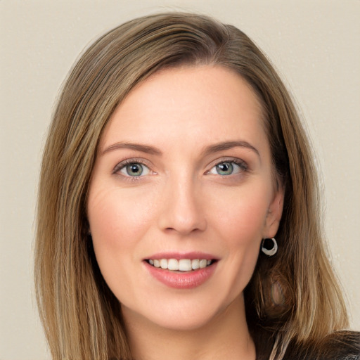 Joyful white young-adult female with long  brown hair and blue eyes