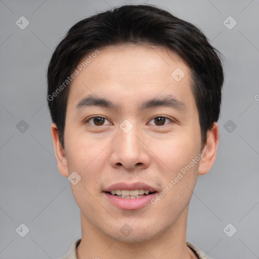 Joyful asian young-adult male with short  brown hair and brown eyes