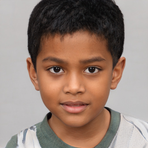 Joyful black child male with short  brown hair and brown eyes