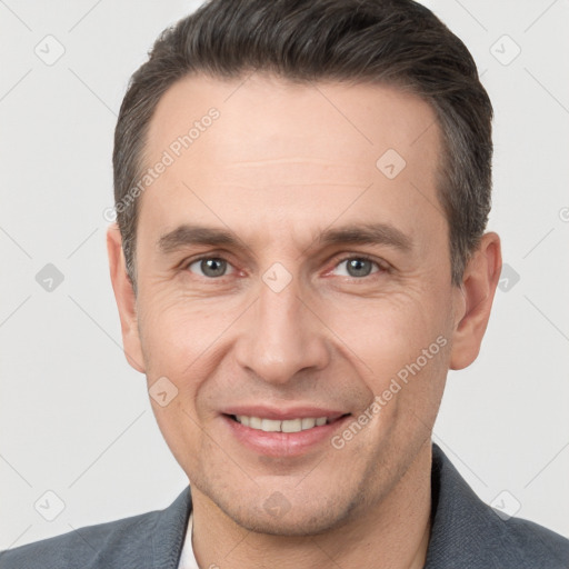 Joyful white adult male with short  brown hair and brown eyes