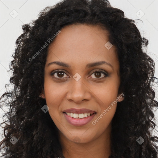 Joyful black young-adult female with long  brown hair and brown eyes