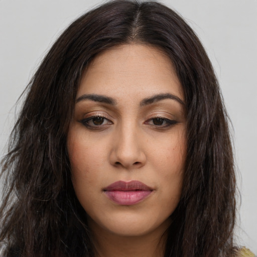 Joyful latino young-adult female with long  brown hair and brown eyes