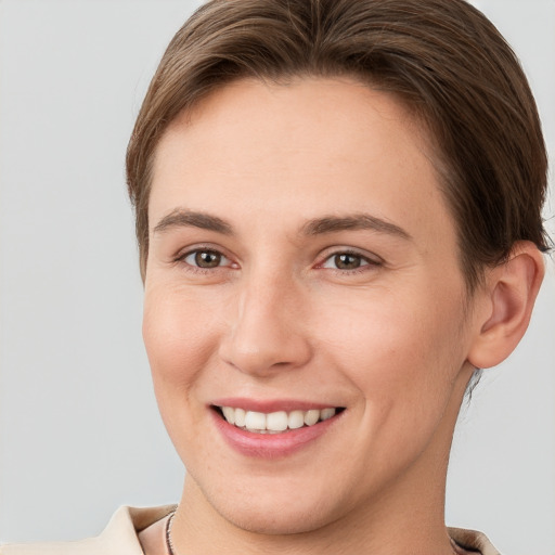 Joyful white young-adult female with short  brown hair and brown eyes