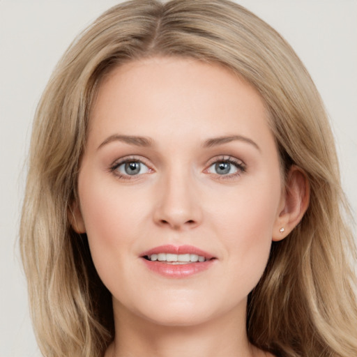 Joyful white young-adult female with long  brown hair and grey eyes