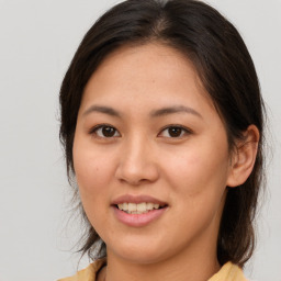 Joyful white young-adult female with medium  brown hair and brown eyes