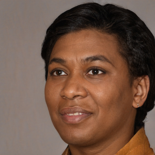 Joyful black adult female with short  black hair and brown eyes